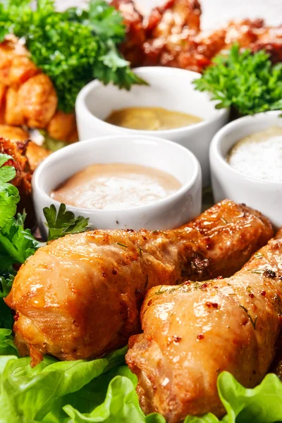 Chicken legs with sauces and spices — Stock Photo, Image