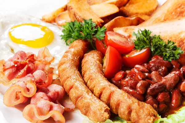 Fried eggs with sausages and subfried bread Royalty Free Stock Images