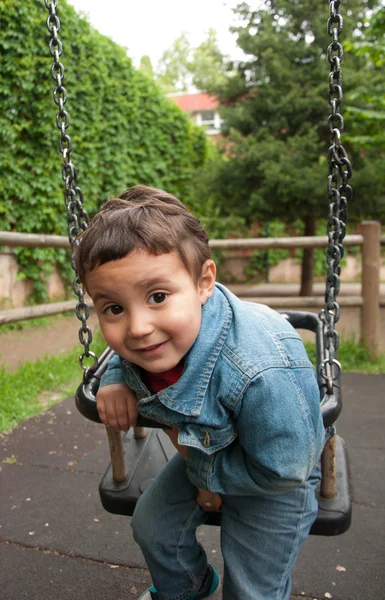 Little cute boy playing on a swing — Stock Photo, Image