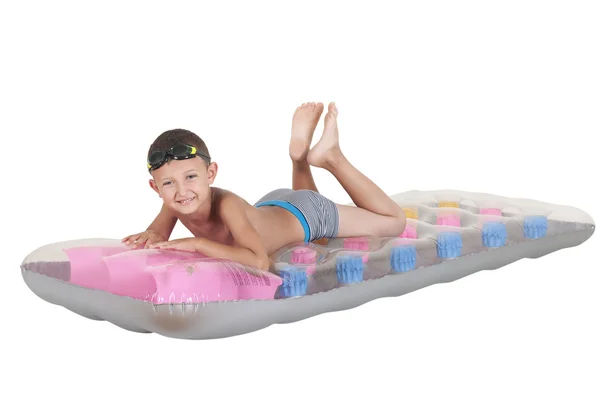 Boy lying on an inflatable mattress — Stock Photo, Image
