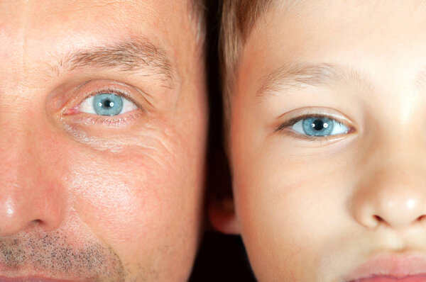 similarity of father and son, young and old faces close-up