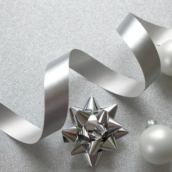 Happy New Year and Merry Christmas. Silver accessories on a shiny silver background
