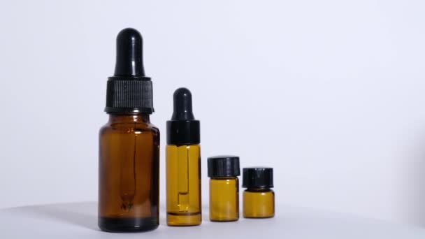 Various empty bottles of essential oils on a white background. — Stock Video