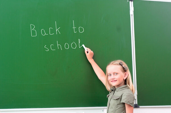 Schoolgirl writing on a blackboard