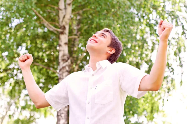 Young man looking to the sky, holding his hands up — Stock Photo, Image