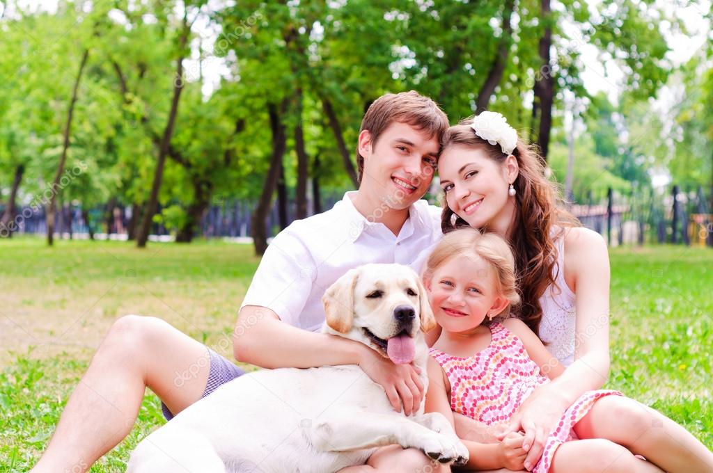 Happy young family with Labrador