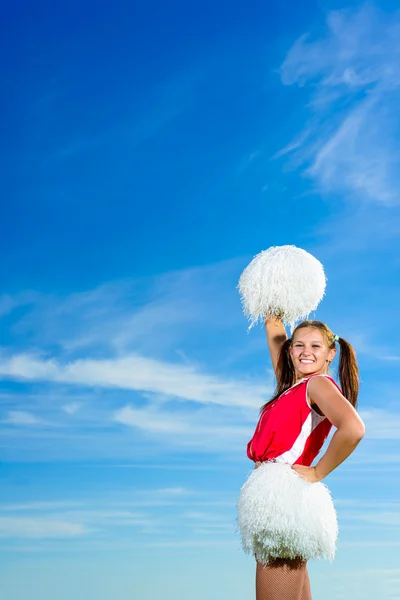 Young cheerleader in red costume with pampon — Stock Photo, Image