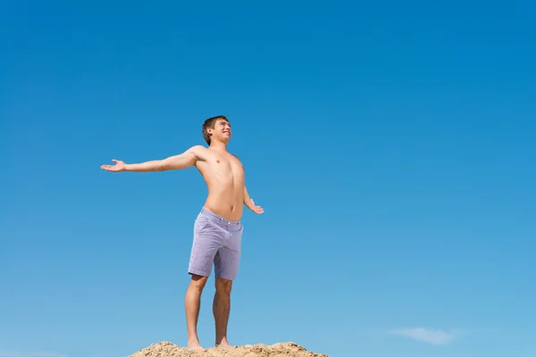 Uomo senza camicia contro cielo blu — Foto Stock