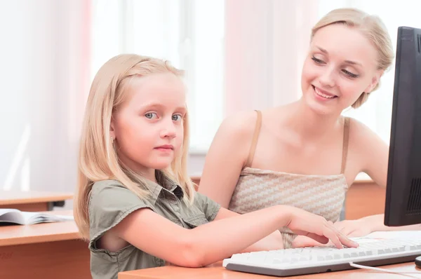 Teacher sitting near pupil — Stock Photo, Image