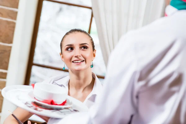 Waiter brings a dish for a nice woman — Stock Photo, Image