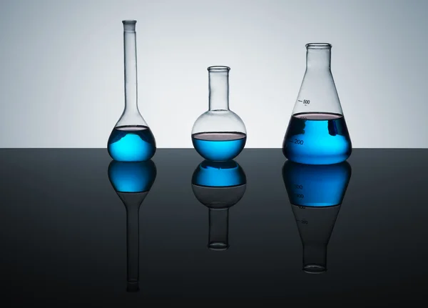 Laboratory buttles with blue liquid — Stock Photo, Image