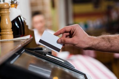 Waiter inserts the card into a computer terminal