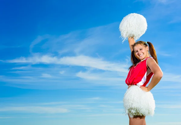 Young cheerleader in red costume with pampon — Stock Photo, Image