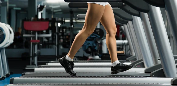 Mujer corriendo en una cinta de correr — Foto de Stock