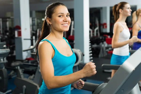 Young women running on a treadmill — Stock Photo, Image