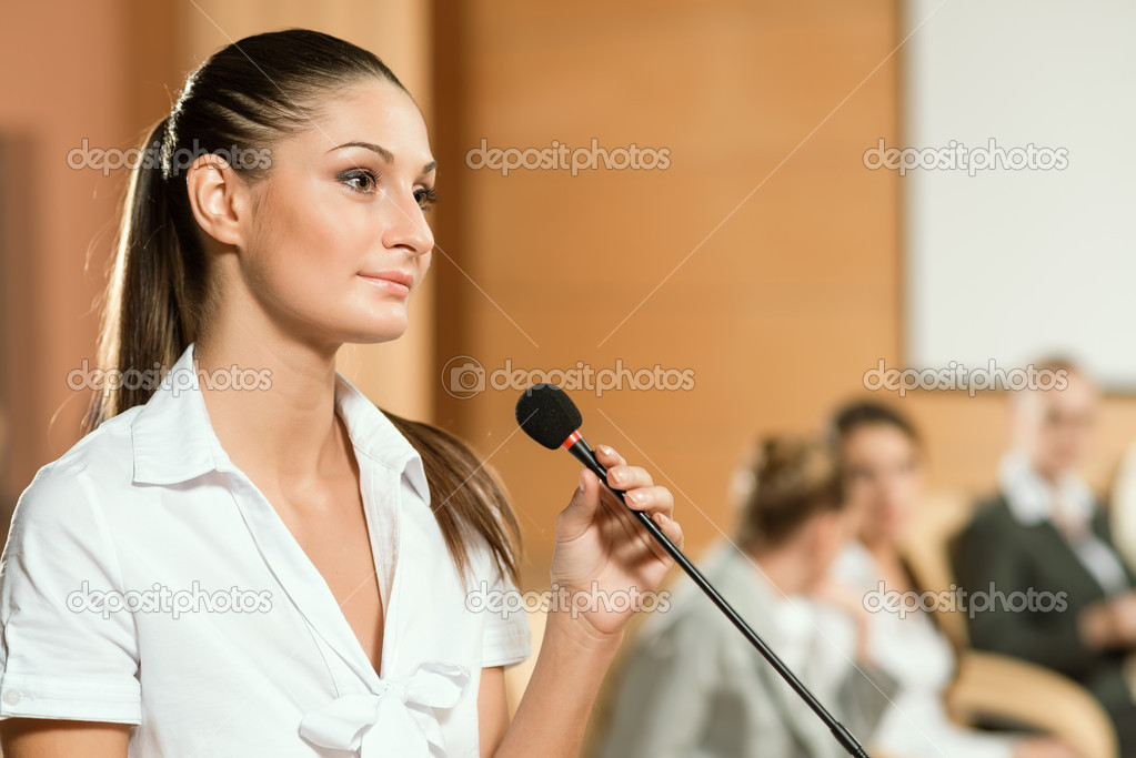 Portrait of a business woman with microphone