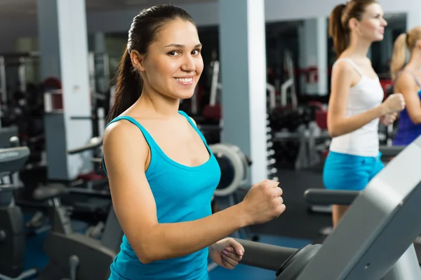 Young women running on a treadmill — Stock Photo, Image