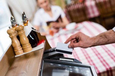 waiter inserts the card into a computer terminal