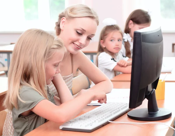 Leraar verklaart de taak schoolmeisje — Stockfoto