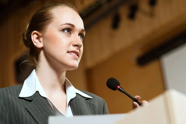 Portrait of a business woman with microphone — Stock Photo, Image