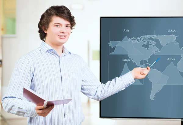 Young business man shows on the monitor charts — Stock Photo, Image