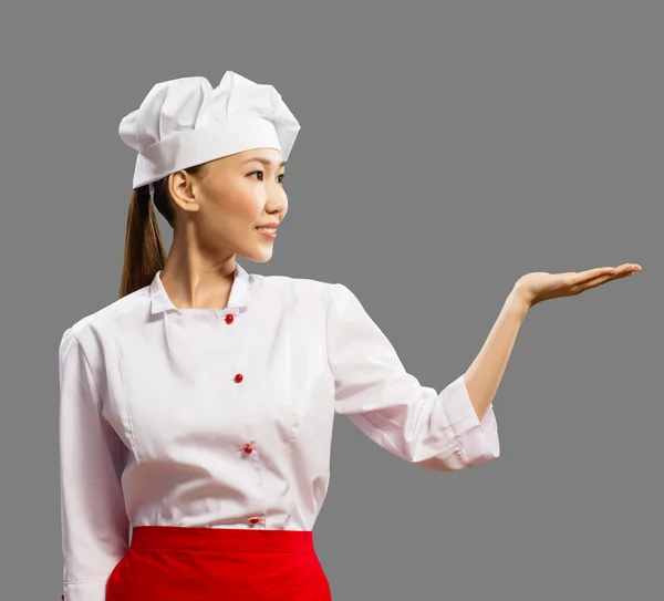 Asian female chef shows his hand — Stock Photo, Image