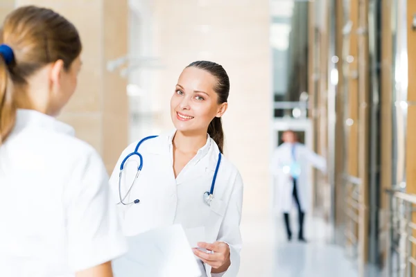 Two doctors talking in the lobby of the hospital — Stock Photo, Image