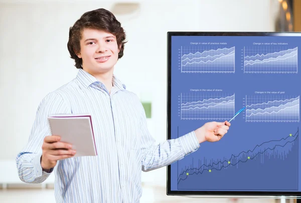 Jungunternehmer zeigt auf dem Monitor Charts — Stockfoto