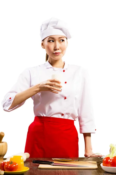 Asian female cook drinking milk — Stock Photo, Image