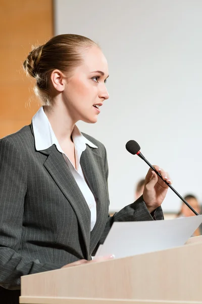 Portrait of a business woman with microphone — Stock Photo, Image