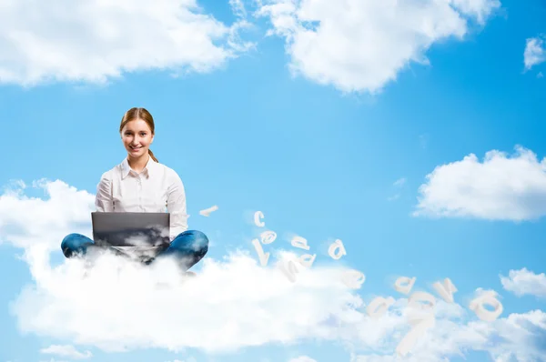 Young girl running in the clouds with a laptop — Stock Photo, Image