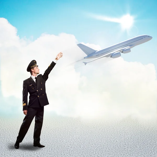 Pilot in the form of extending a hand to airplane — Stock Photo, Image