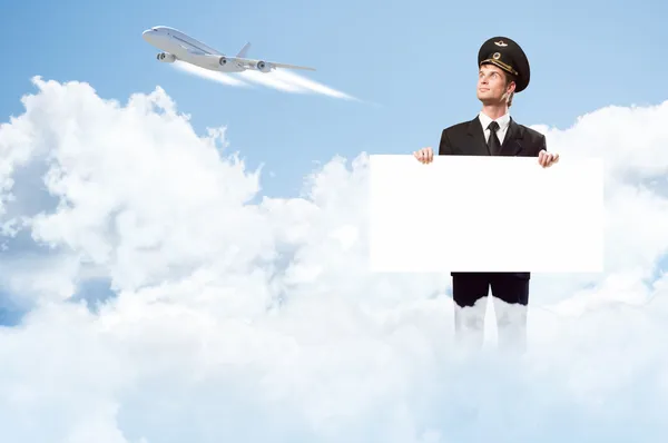 Pilot in the form of holding an empty billboard — Stock Photo, Image