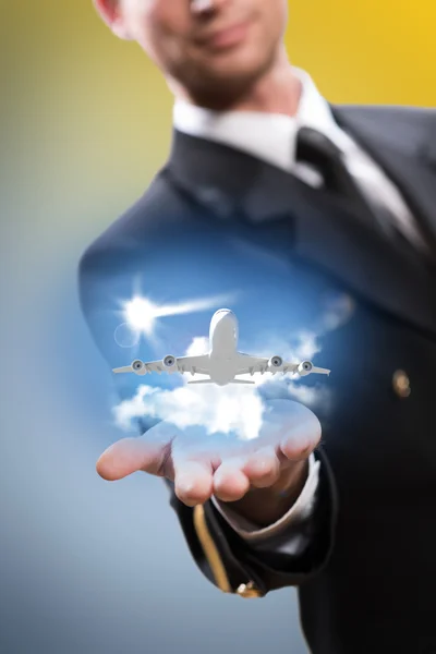 Pilot in the form of extending a hand to airplane — Stock Photo, Image