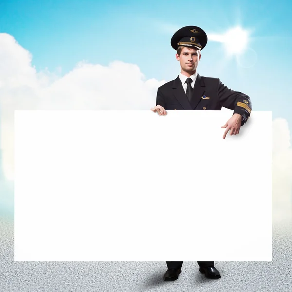 Pilot in the form of holding an empty billboard — Stock Photo, Image