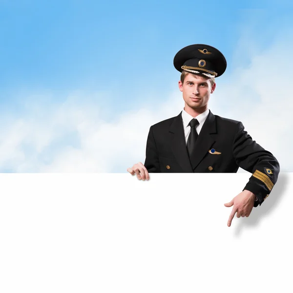 Pilot in the form of holding an empty billboard — Stock Photo, Image