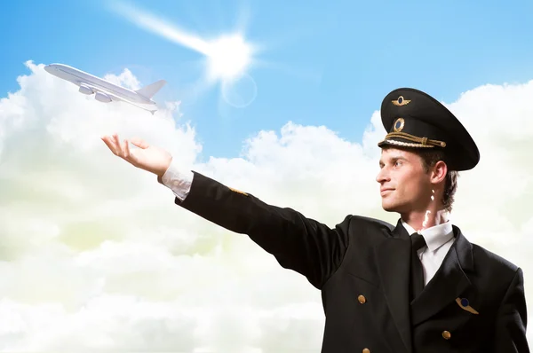 Pilot in the form of extending a hand to airplane — Stock Photo, Image