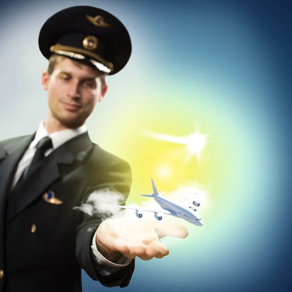 Pilot in the form of extending a hand to airplane — Stock Photo, Image