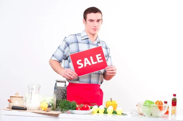 Portrait of a young man, hold sale mark — Stock Photo, Image