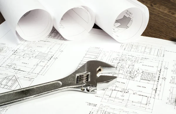 Wrench and drawings, construction still life — Stock Photo, Image