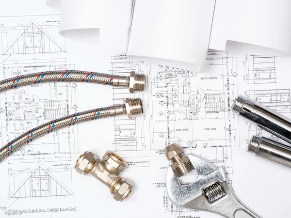 Plumbing and drawings, construction still life — Stock Photo, Image