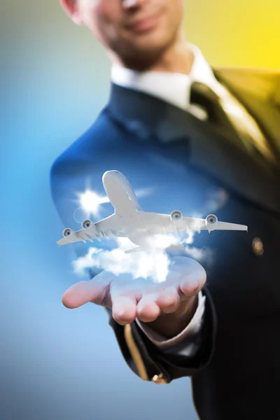 Pilot in the form of extending a hand to airplane — Stock Photo, Image