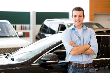 bir arabanın yakınında duran adam