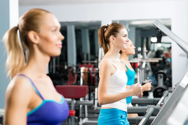 Women running on a treadmill — Stock Photo, Image