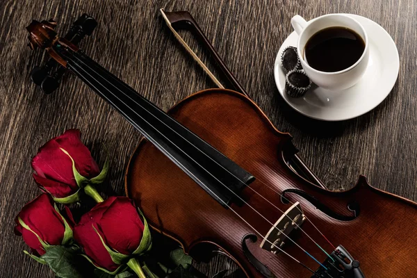 Violin, rose, coffee and music books