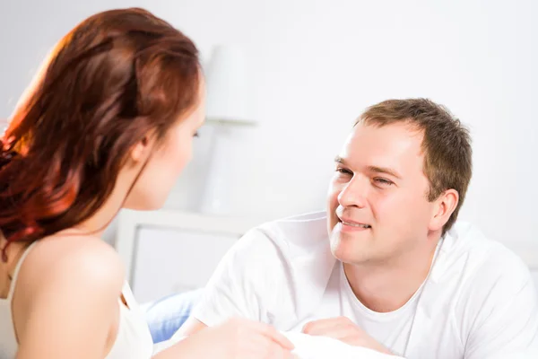 Jonge man liggend in bed met zijn vriendin — Stockfoto