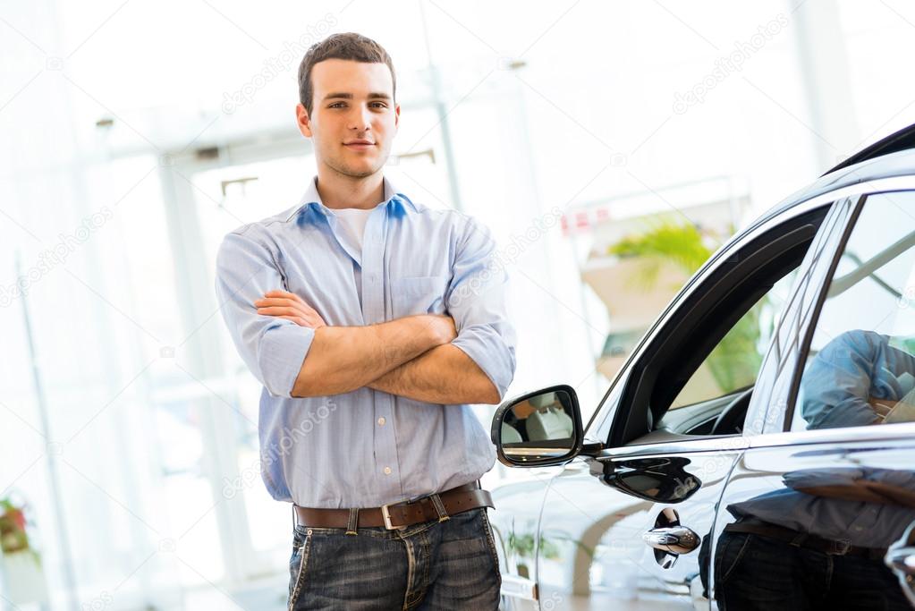 man standing near a car