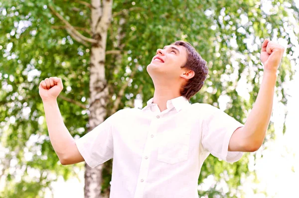 Young man looking to the sky, holding his hands up — Stock Photo, Image