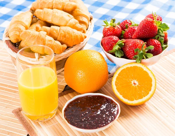 Tidlig morgenmad, juice, croissanter og marmelade - Stock-foto
