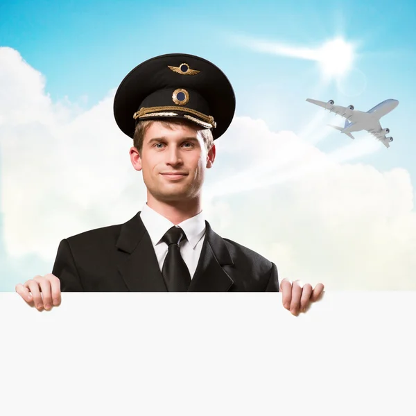 Pilot in the form of holding an empty billboard — Stock Photo, Image